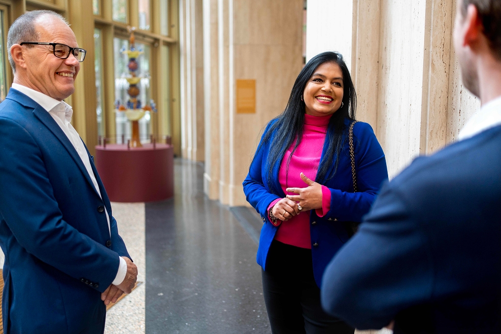 3 collega's praten met elkaar in de lobby