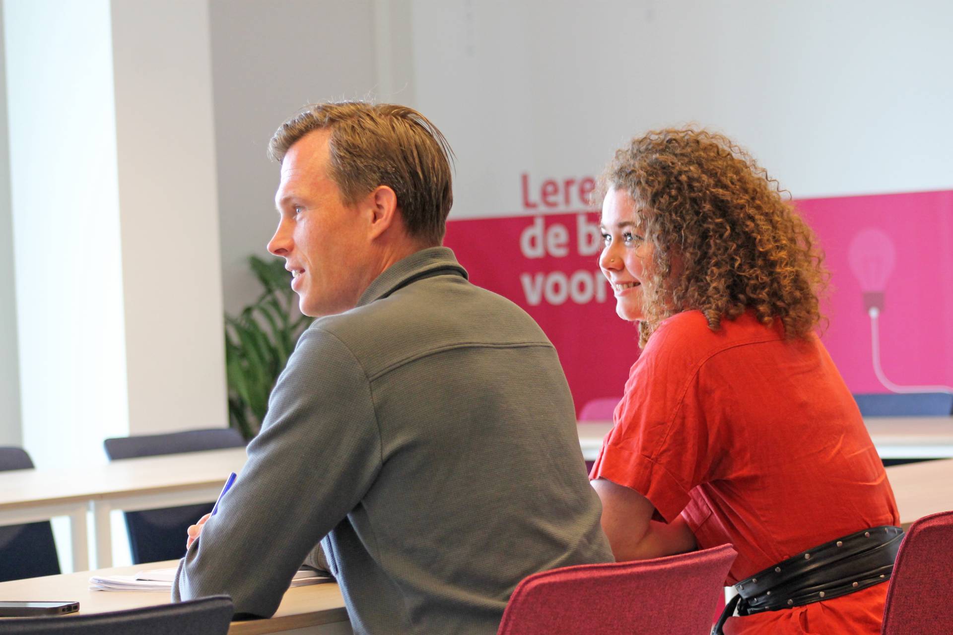 Twee collega's zitten samen naast elkaar