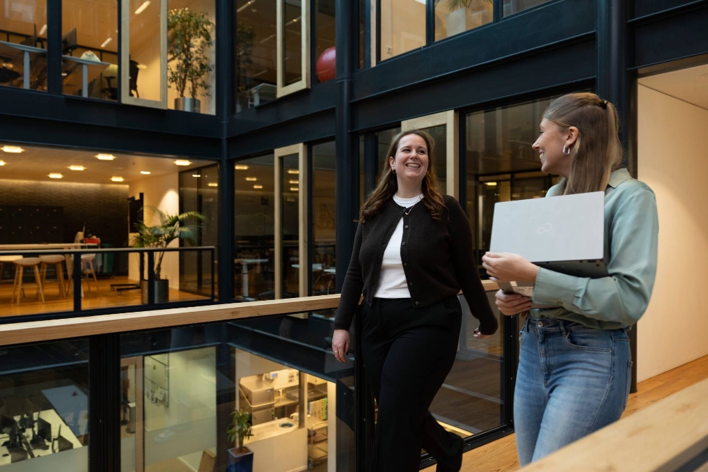Trainees van de Starterspool Communicatie lopen samen in de wandelgangen